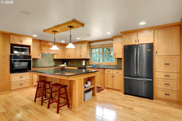 24780 Lavell Rd, Junction City, OR 97448 - kitchen featuring black appliances, premium range hood, a sink, light brown cabinets, and light wood finished floors
