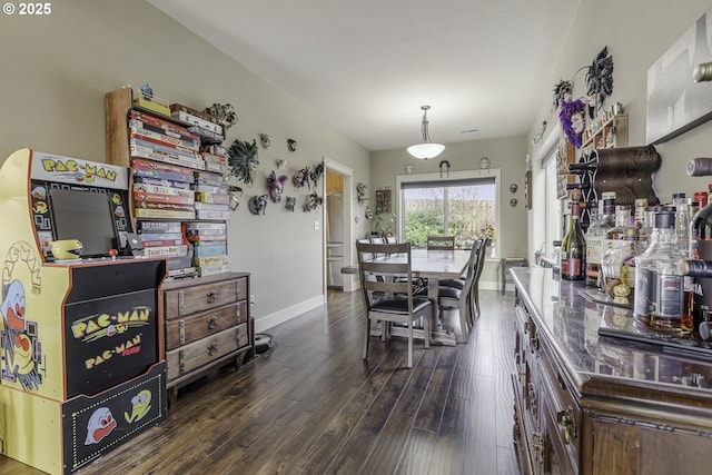 dining room featuring baseboards and wood finished floors