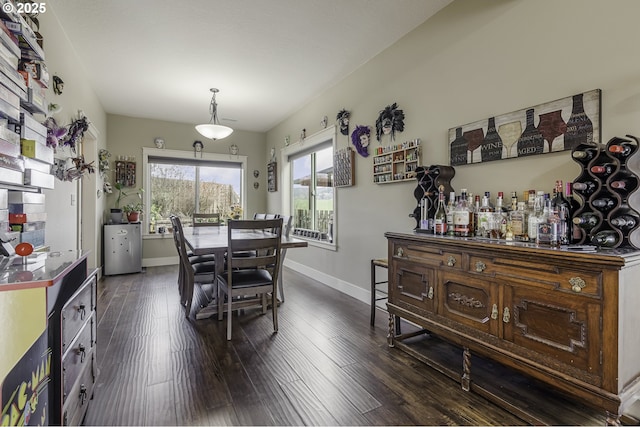 dining space with dark wood-style floors and baseboards