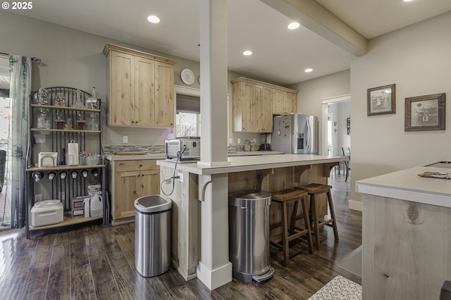 kitchen with dark wood-style floors, light countertops, stainless steel fridge with ice dispenser, and light brown cabinetry