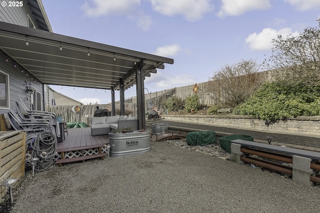 view of patio featuring an outdoor hangout area, a fenced backyard, and a wooden deck