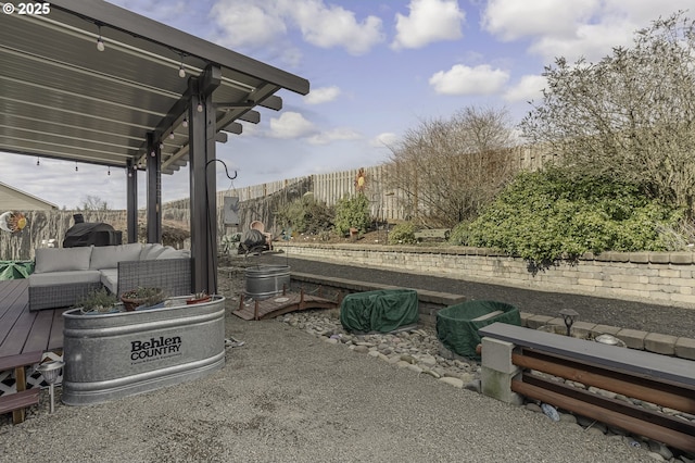 view of patio / terrace with a fenced backyard, an outdoor living space, and a wooden deck