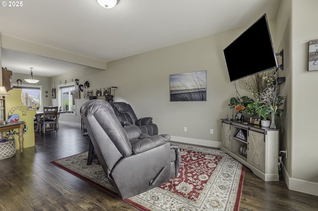 living area featuring hardwood / wood-style flooring and baseboards