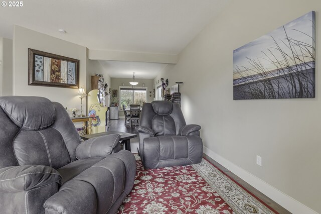 living room with baseboards and wood finished floors