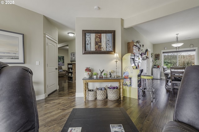 corridor featuring lofted ceiling with beams, wood finished floors, and baseboards