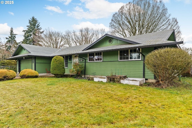 view of front facade with a garage and a front lawn