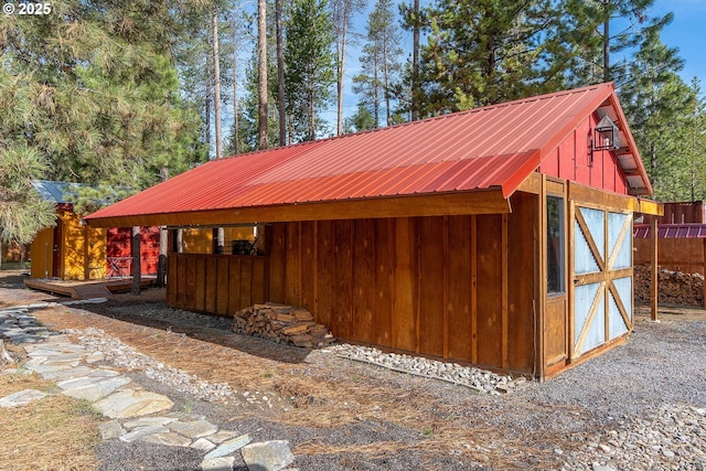 view of outbuilding featuring an outbuilding and fence