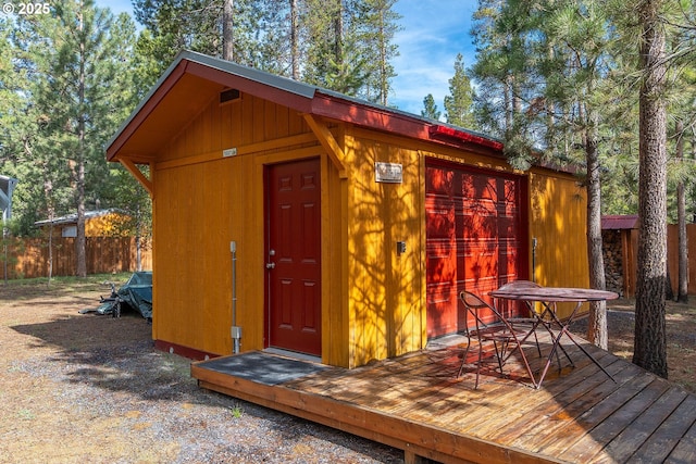 view of outbuilding with an outbuilding and fence