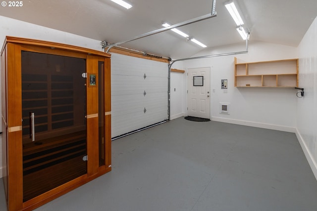 garage featuring baseboards and a sauna