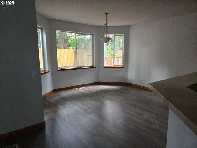 12174 SW Quail Creek Ln, Portland, OR 97223 - unfurnished dining area with baseboards and dark wood-type flooring