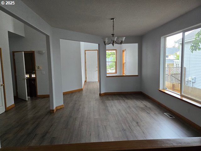 12174 SW Quail Creek Ln, Portland, OR 97223 - unfurnished dining area featuring a chandelier and wood finished floors