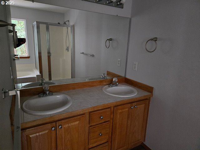 12174 SW Quail Creek Ln, Portland, OR 97223 - bathroom featuring a stall shower, double vanity, and a tub to relax in