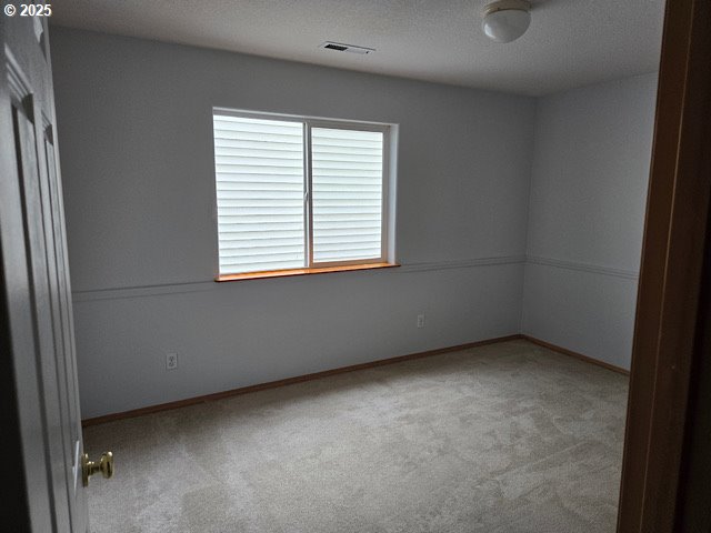 12174 SW Quail Creek Ln, Portland, OR 97223 - carpeted empty room featuring a textured ceiling and baseboards