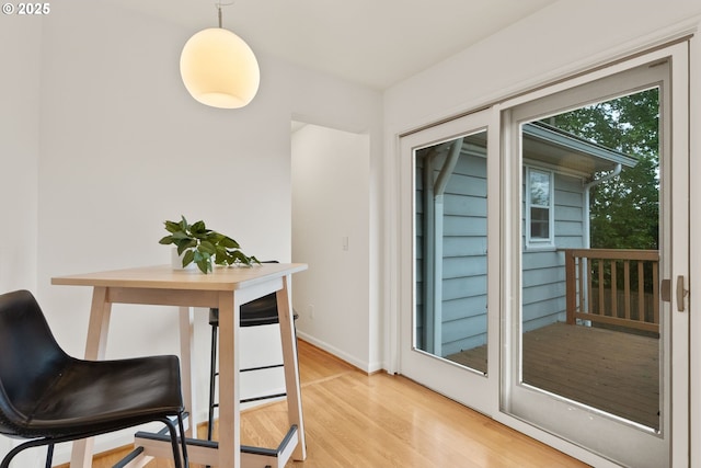 dining space featuring wood finished floors and baseboards