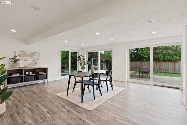 dining area with plenty of natural light, wood finished floors, recessed lighting, baseboards, and beam ceiling