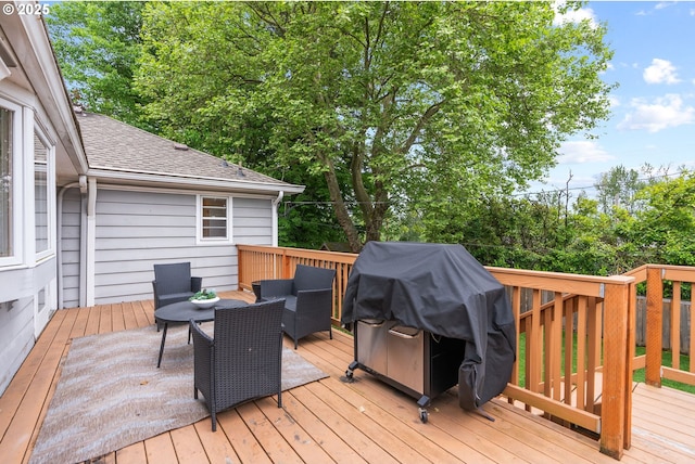 wooden terrace with grilling area and an outdoor hangout area