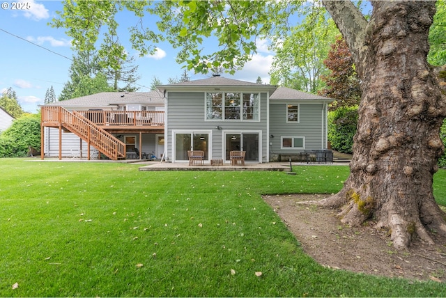 rear view of property with stairs, a wooden deck, a yard, and a patio area