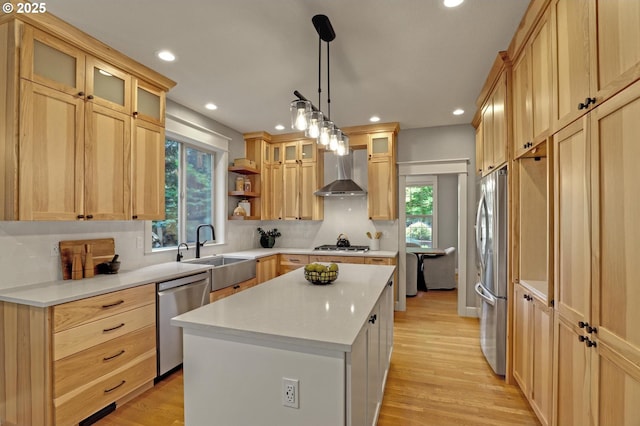 850 NW 114th Ave, Portland, OR 97229 - kitchen with stainless steel appliances, wall chimney exhaust hood, a sink, a center island, and recessed lighting