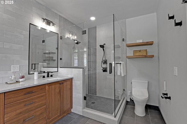 850 NW 114th Ave, Portland, OR 97229 - full bathroom with tile patterned floors, toilet, vanity, a shower stall, and tile walls
