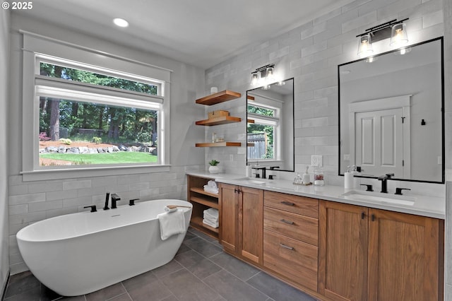 850 NW 114th Ave, Portland, OR 97229 - bathroom featuring tile walls, double vanity, a freestanding bath, and tile patterned flooring