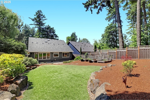 850 NW 114th Ave, Portland, OR 97229 - rear view of house featuring a vegetable garden and roof with shingles