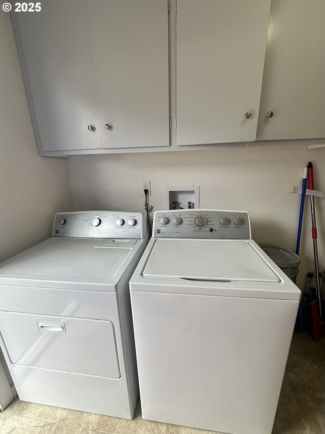 laundry room with separate washer and dryer and cabinet space