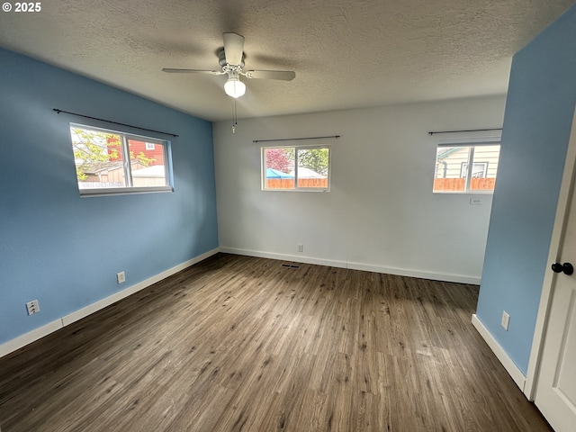 empty room with ceiling fan, a healthy amount of sunlight, and a textured ceiling