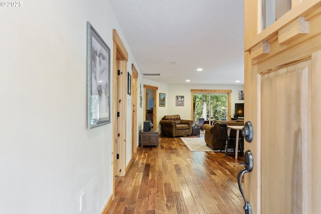 hallway with recessed lighting and light wood-style floors