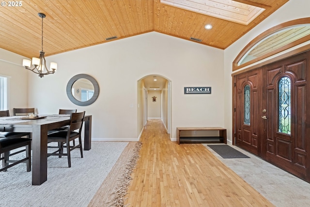 54601 Winterberry Dr, Bandon, OR 97411 - foyer with wood ceiling, arched walkways, a chandelier, lofted ceiling, and light wood-style floors