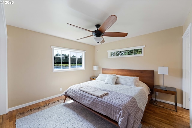 54601 Winterberry Dr, Bandon, OR 97411 - bedroom with wood finished floors, baseboards, and ceiling fan