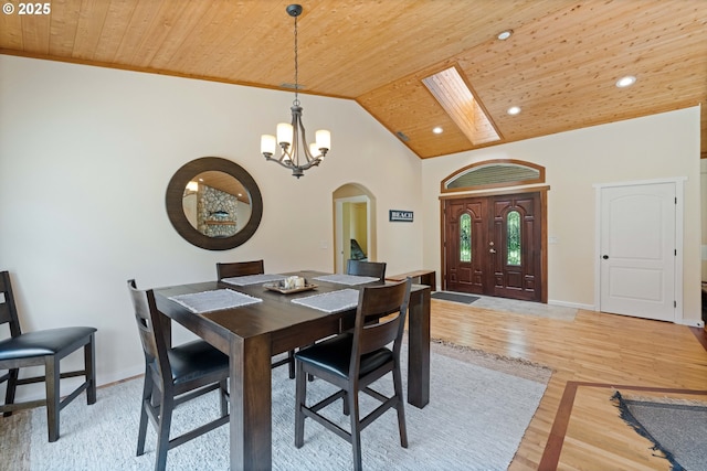 54601 Winterberry Dr, Bandon, OR 97411 - dining area with arched walkways, wooden ceiling, a chandelier, light wood-style flooring, and lofted ceiling