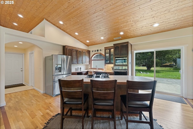 54601 Winterberry Dr, Bandon, OR 97411 - kitchen with black appliances, plenty of natural light, light countertops, wooden ceiling, and arched walkways