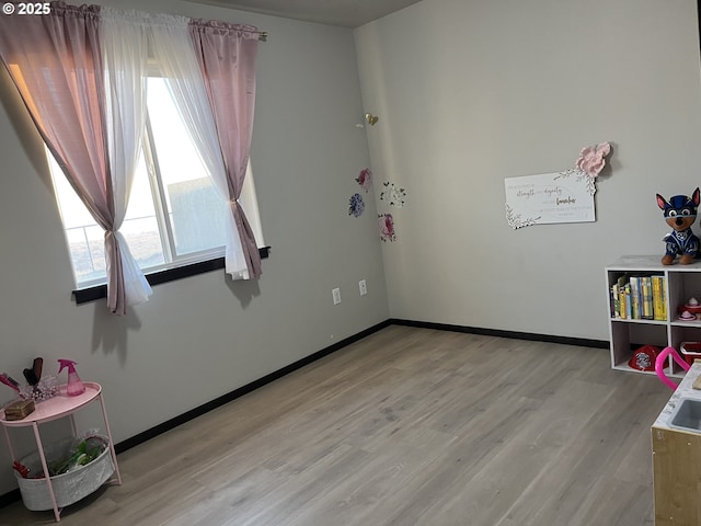 interior space with light wood-style flooring and baseboards