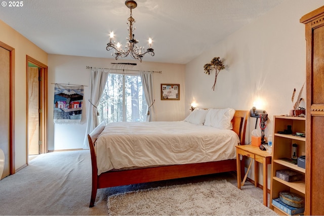 bedroom with a chandelier, carpet, and access to exterior