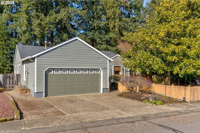 exterior space with concrete driveway and fence