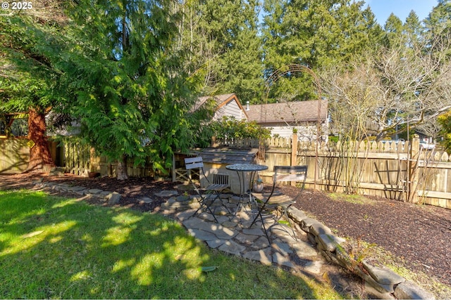 view of yard with fence and a patio