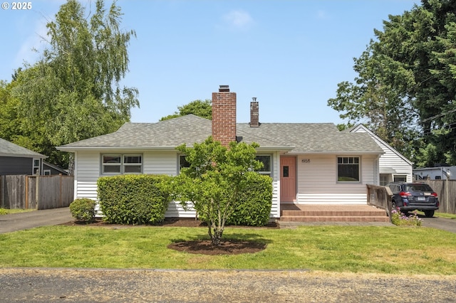 8735 NE Alberta St, Portland, OR 97220 - view of front of house featuring a chimney, roof with shingles, and asphalt driveway