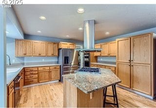 kitchen with light wood finished floors, a breakfast bar area, appliances with stainless steel finishes, and island exhaust hood