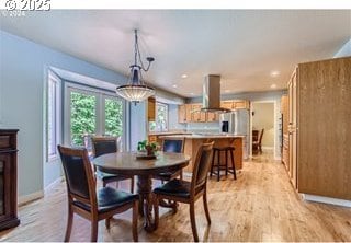 dining space featuring recessed lighting, baseboards, and light wood finished floors