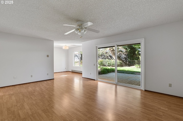 10915 SW Meadowbrook Dr Unit 22, Portland, OR 97224 - empty room with a baseboard heating unit, ceiling fan, a textured ceiling, and wood finished floors