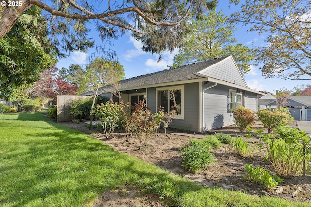 10915 SW Meadowbrook Dr Unit 22, Portland, OR 97224 - view of home's exterior featuring a lawn and roof with shingles