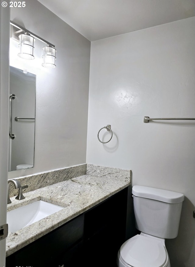 bathroom featuring toilet and vanity