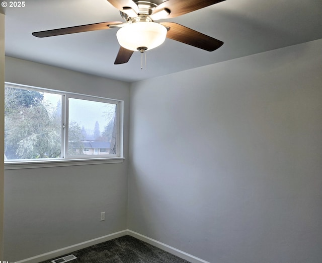 carpeted spare room featuring ceiling fan