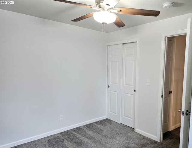 unfurnished bedroom featuring a closet, ceiling fan, and dark carpet