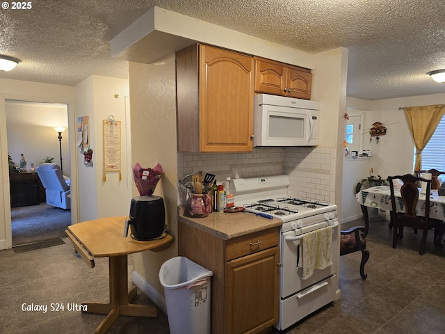 kitchen with white appliances and tasteful backsplash