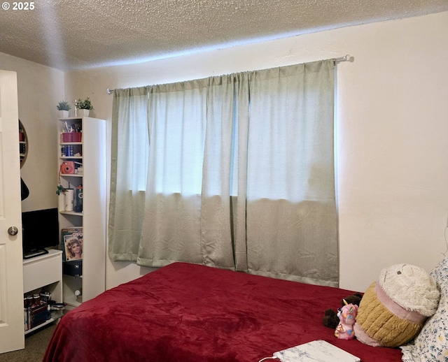 carpeted bedroom featuring a textured ceiling