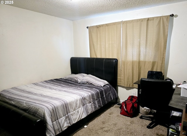 carpeted bedroom featuring a textured ceiling