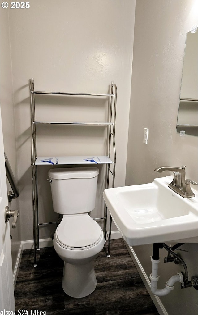 bathroom with sink, hardwood / wood-style floors, and toilet