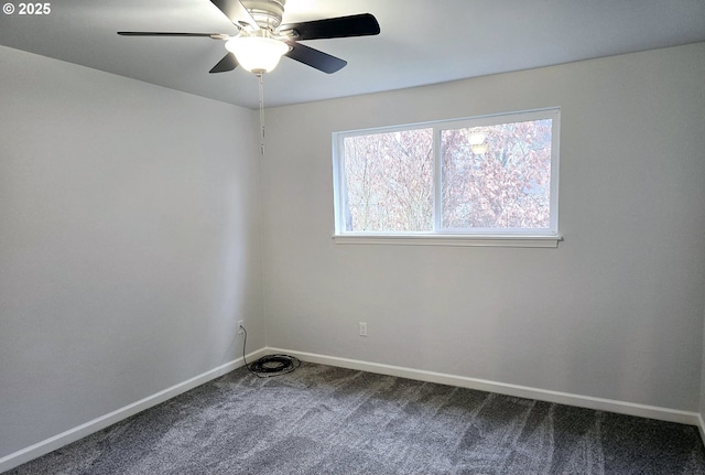 spare room with ceiling fan and carpet