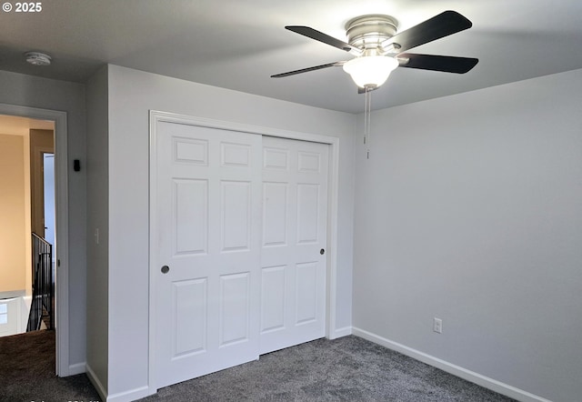 unfurnished bedroom featuring dark carpet, ceiling fan, and a closet